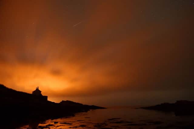 A shooting star in the skies over the Bathing House at Howick in Northumberland as the annual Perseids meteor shower peaked, delighting viewers in the Midlands and the North. (Picture: Owen Humphreys/PA Wire)