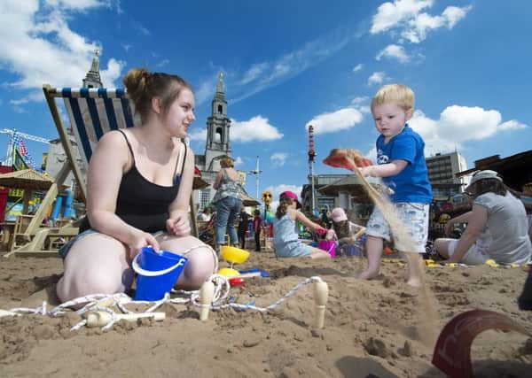 Kimberley Green with Ryan Green, two, from Headingley, at the Leeds Beach in Millennium Square