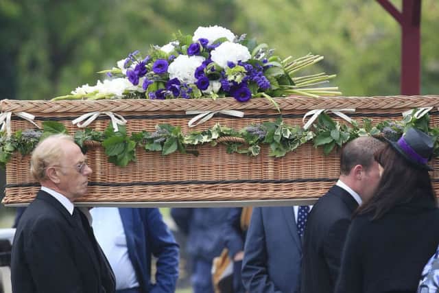 The coffin of George Cole is carried into Reading Crematorium for his funeral.