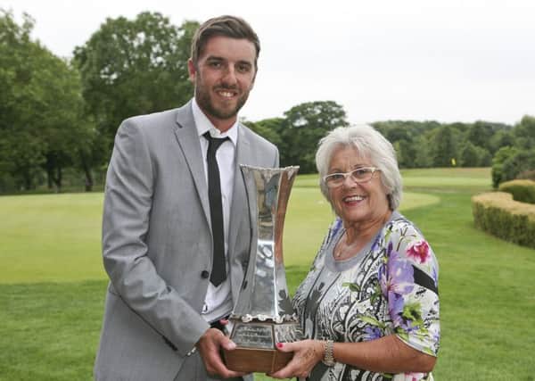 Sam Haywood receives the Lee Westwood Trophy from the Ryder Cup star's mother, Trish (Picture: Driving Golf PR).