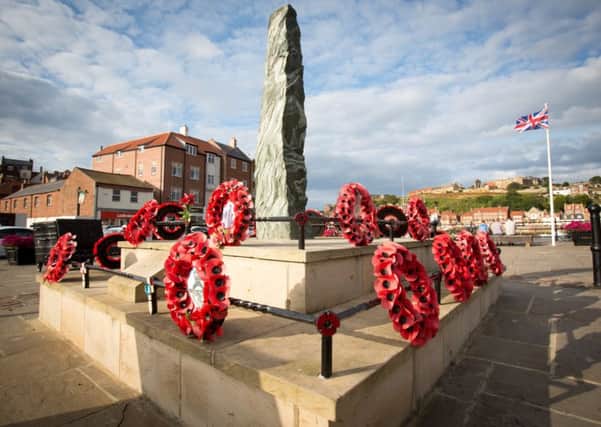 Controversial poppy wreaths on Whitby war memorial before they were removed. Picture: Ross Parry Agency