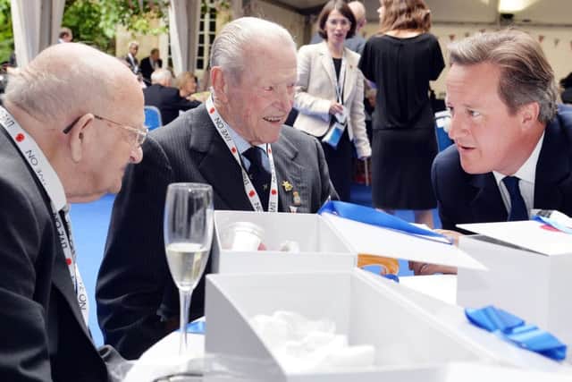 Prime Minister David Cameron talks Ted Maslen-Jones (centre),96, who served as an Air Observer, attached to the RAF in the Far East and fellow veteran Gordon Smith (left) during a veterans' reception.