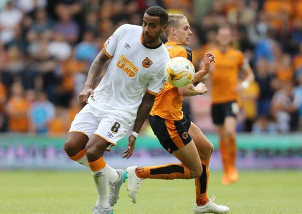 Hull City's Tom Huddlestone battles for possession with Wolverhampton Wanderers' Dave Edwards. Picture: Barrington Coombs/EMPICS Sport.