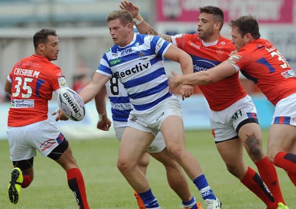 Halifax's Jacob Fairbanks looks to offload in the tackle against Hull KR.
