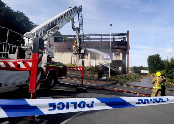 Firefighters damp down following a fire at Farnley Sports and Social Club. PIC: James Hardisty