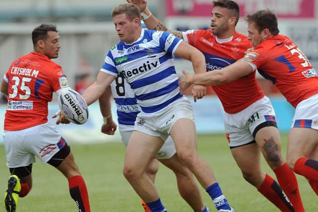 Halifax's Jacob Fairbanks looks to offload in the tackle against Hull KR.