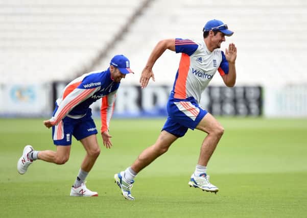 England's Alastair Cook (right) and Mark Wood.