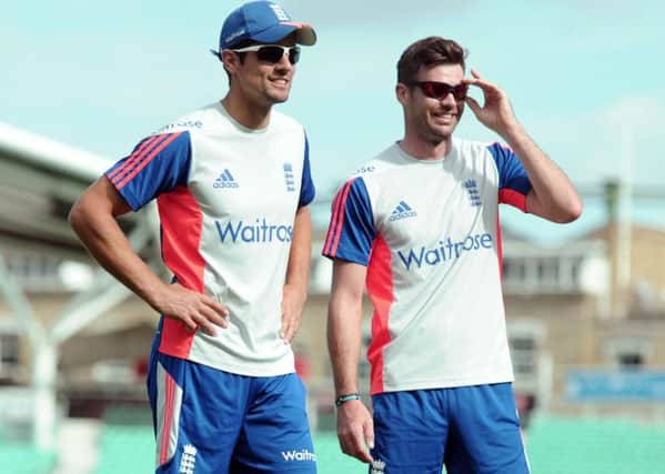England's Alastair Cook (left) speaks with James Anderson (right)