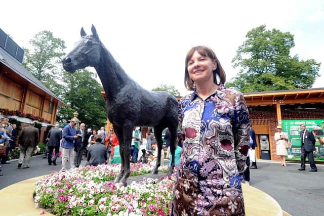 Date:19th August 2015. Picture James Hardisty (JH1009/94n)
Welcome to Yorkshire York Races Ebor Festival 2015. Pictured Lady Jane Cecil next to the Frankel statue.