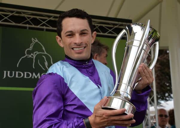 Jockey Silvestre de Sousa celebrates with the trophy after riding Arabian Queen to victory in the Juddmonte International Stakes during day one of the Welcome to Yorkshire Ebor Festival at York Racecourse.