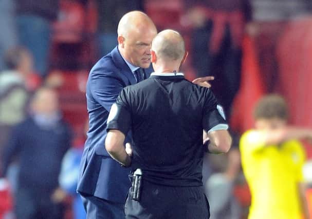 Leeds manager Uwe Rosler has stern words with referee Gavin Ward.