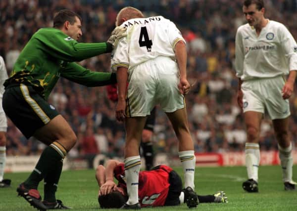 Leeds United's Alf-Inge Haaland stands over Manchester United's Roy Keane after he was tackled by him.