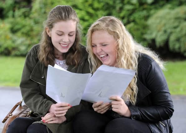 Sarah Jones, 5A* and 4A,  and Grace Stephenson, 2 A* and 7A, celebrate together at Benton Park School GCSE results day.  Picture: Bruce Rollinson
