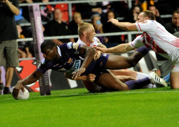 MEMORABLE: 
Huddersfield's Jermaine McGillvary scores his superb try against St Helens.
Picture: Jonathan Gawthorpe.