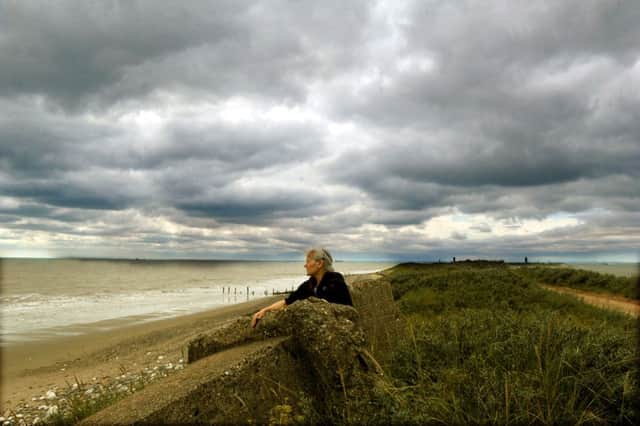 Mary Mathison from Hedon looking at the heavy cloud formation from Spurn Point over the North Sea, part of the 'Spanish Plume'.