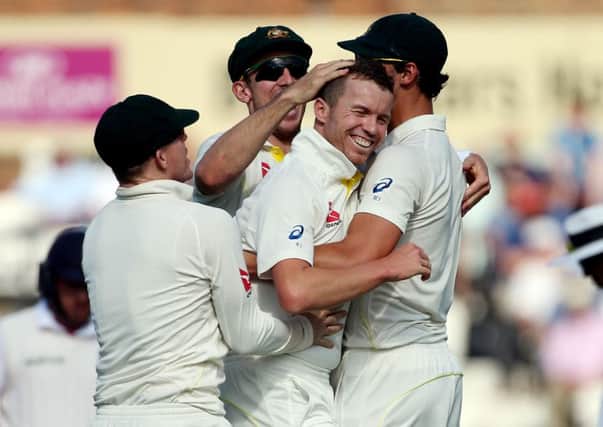 Australia's Peter Siddle celebrates taking the wicket of Adam Lyth
