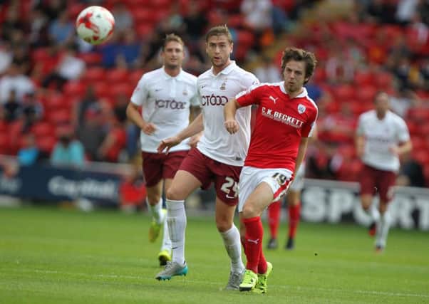 Bradford City's Steven Davies and Barnsley's Ben Pearson chase the loose ball.