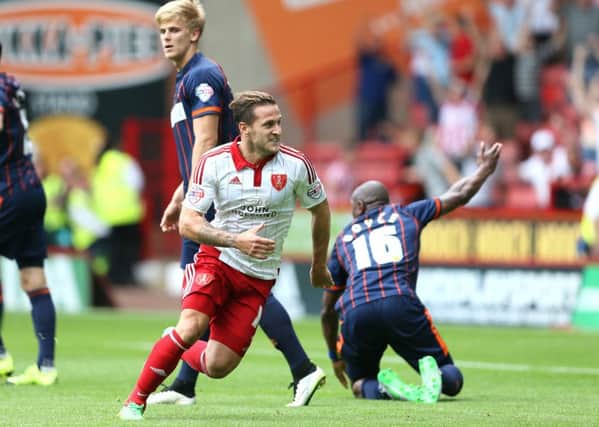 UP AND RUNNING: Striker Billy Sharp races away to celebrate his first goal for Sheffield United since signing from Leeds United. Pictures: Martyn Harrison