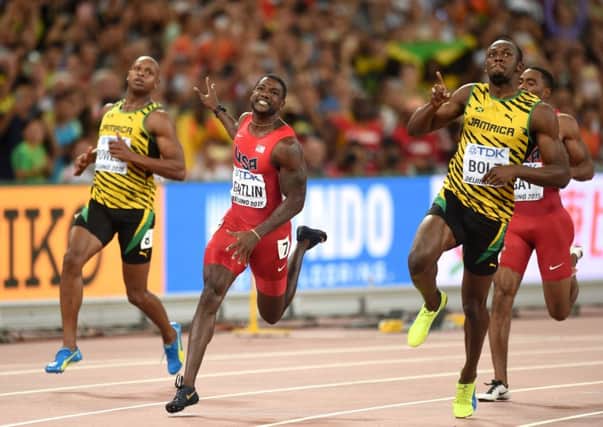 Jamaica's Usain Bolt, right, crosses the line to win the gold medal in the men's 100m ahead of the USA's Justin Gatlin, centre, at the IAAF World Championships at the Beijing National Stadium, China (Picture: Adam Davy/PA Wire).