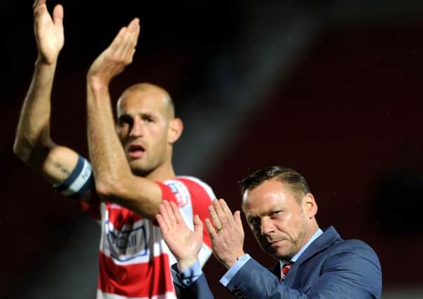 Captain Rob Jones and manager Paul Dickov applaud the crowd after Doncaster Rovers win over Leeds United (Picture: Jonathan Gawthorpe).
