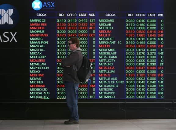A man watches electronic boards at the Australian Stock Exchange (AP Photo/Rick Rycroft)