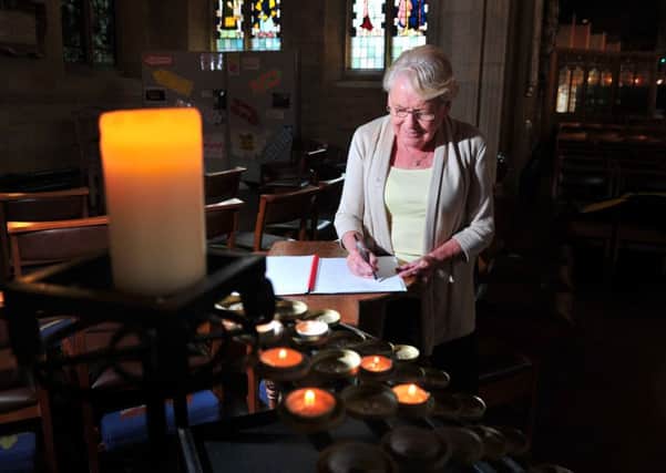 Patricia Field signs a book of condolence in memory of 'Jesus Man' Geoffrey Brindley at Bradford Cathedral. PIC: Tony Johnson