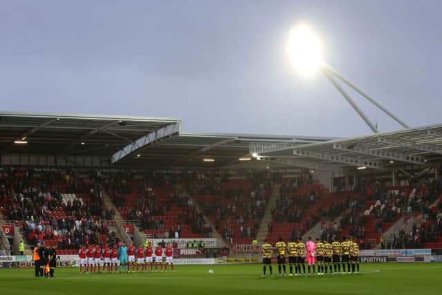 Players observe a minutes silence in memory of the victims of the Shoreham Airshow crash before the Capital One Cup, second round match at the New York Stadium, Rotherham.