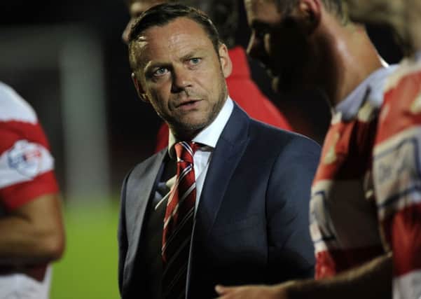 ENCOURAGED: Paul Dickov speaks to his players before extra-time.