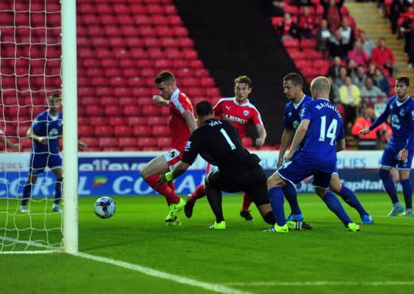 Barnsley's Marley Watkins scores the second goal bundling the ball past Everton keeper Joel Robles. Picture: Tony Johnson.