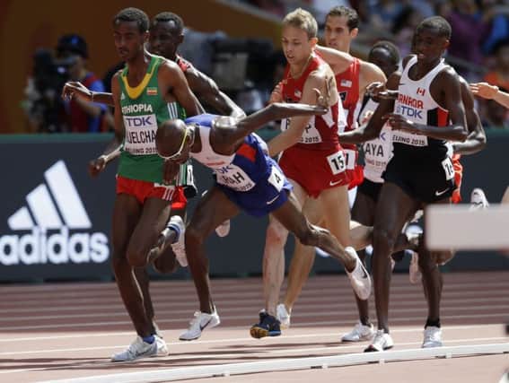 Britain's Mo Farah stumbles and almost falls in his 5000m round one heat in Beijing.