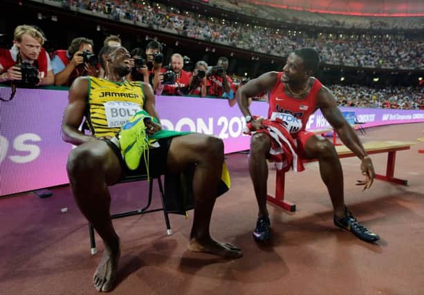 Jamaica's Usain Bolt, left, greets silver medalist United States' Justin Gatlin as he celebrates after winning gold in the men's 200m final  in Beijing. AP Photo/Andy Wong.