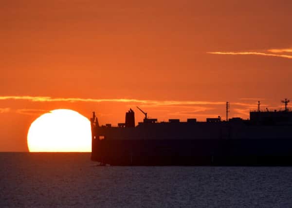 A ship awaits in the North Sea to enter the River Tyne at sunrise, as millions of Britons planning a bank holiday getaway should expect a "messy" weekend of weather, forecasters have warned. PRESS ASSOCIATION Photo. Picture date: Friday August 28, 2015. Forecasters have warned most of the country should prepare for showers, with thunderstorms predicted in the South East on Saturday night. Photo credit should read: Owen Humphreys/PA Wire