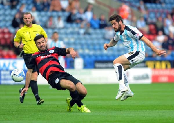 Huddersfield's Jacob Butterfield shoots past QPR's Michael Doughty.
 
(Picture: Jonathan Gawthorpe)
