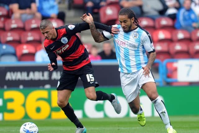 Huddersfield's Sean Scannell battles with QPR's Paul Konchesky. (Picture: Jonathan Gawthorpe)