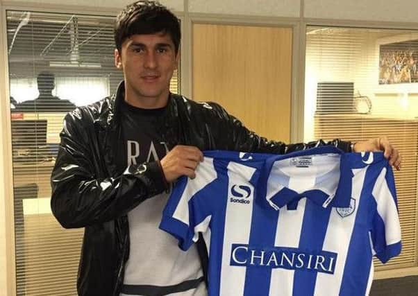 Fernando Forestieri holds the Sheffield Wednesday shirt after signing on Saturday