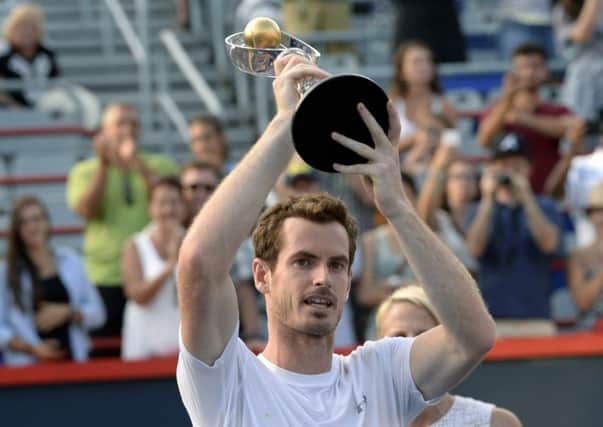 Britains Andy Murray hoists the Rogers Cup trophy above his head following his defeat of world No 1 Novak Djokovic, of Serbia, in the mens final in Montreal earlier this month (Picture: Paul Chiasson/AP).