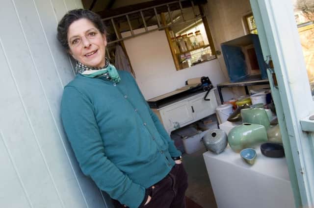 Ruth King in her studio  with her salt glazed pots