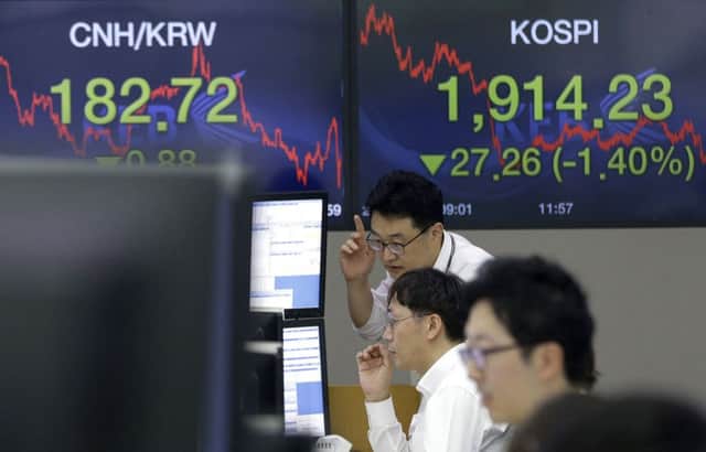 Currency traders watch monitors at the foreign exchange dealing room of the KEB Hana Bank headquarters in Seoul, South Korea