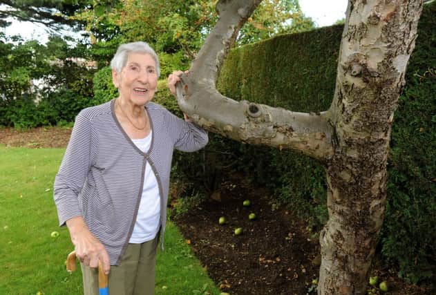 Min Marks, 94, in her garden at her home in Leeds