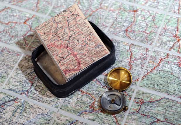 The compas Bertie Ratcliffe's mother sent him in a toffee tin & the maps he never received until after the war. Both are now housed  in the special collections department of Brotherton Library at the University of Leeds. (Picture : Jonathan Gawthorpe).