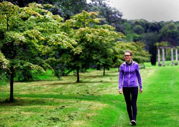 Freya Douglas walking through a tree lined avenue at Thorp Perrow Arboretum near Bedale. (GL1007/21e)