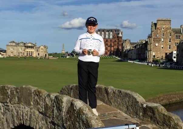 Doncaster GC junior Josh Berry stands on the swilcan Bridge at St Andrews after his victory in the adidas Wee Wonders British championship.