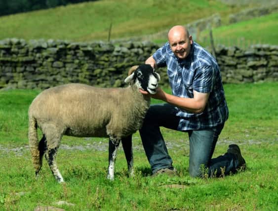 John Bland, the chairman of Moorcock Show, with a Swaledale ewe he is showing at this years event in Mossdale near Hawes tomorrow. Picture: Gary Longbottom
