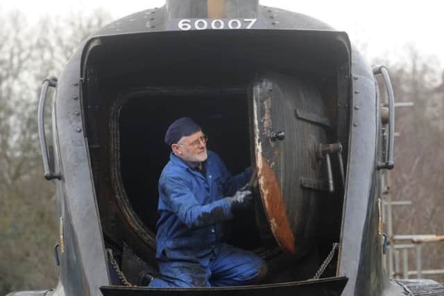 Peter James works on the smoke box of the Sir Nigel Gresley in the yard at Grosmont.  Picture: Gerard Binks.