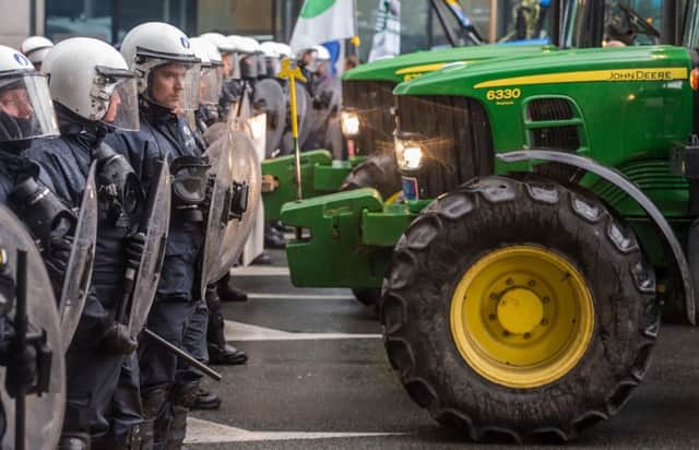 Police officers block tractors during today's farmers demonstration in Brussels. (AP Photo/Geert Vanden Wijngaert)