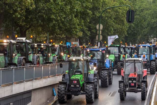 Tractors drive down a main avenue in Brussels.  (AP Photo/Geert Vanden Wijngaert)