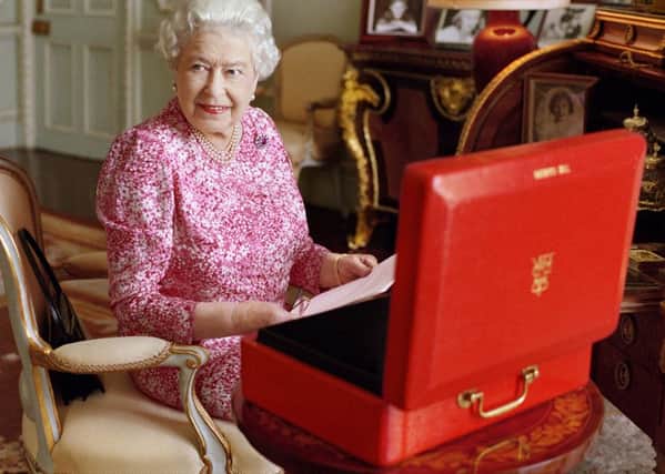 The Queen with an official red box in a photograph issued by Buckingham Palace.