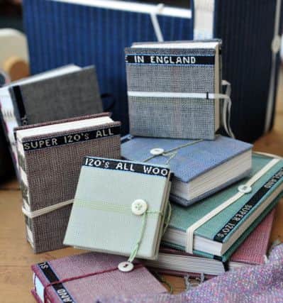 Notebooks in the gallery at Sunny Bank Mills in Farsley made from the cloth produced by Edwin Woodhouse on the site. Picture by Tony Johnson.