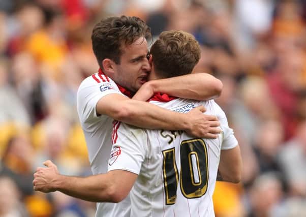 Sheffield United's Jose Baxter celebrates his side's second goal with scorer Billy Sharp.