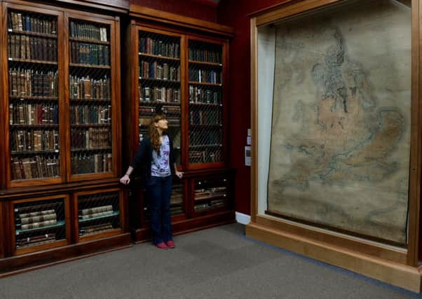 Sarah King, Curator of Natural Sciences at York Museum Trust, looking at the 200 year old-William Smith geological map of Britain